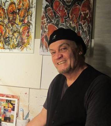 Artist Matt Jones in front of paintings
