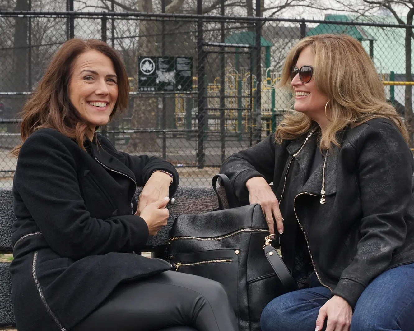 Two women talking together on a park bench