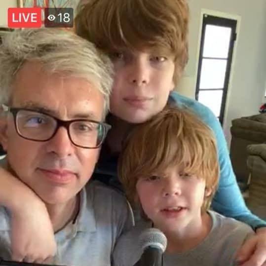 Shane with two sons in front of piano